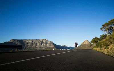 Active person running on a mountain trail.
