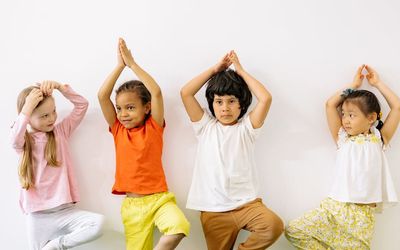 Beginner learning a new yoga pose with a smile.